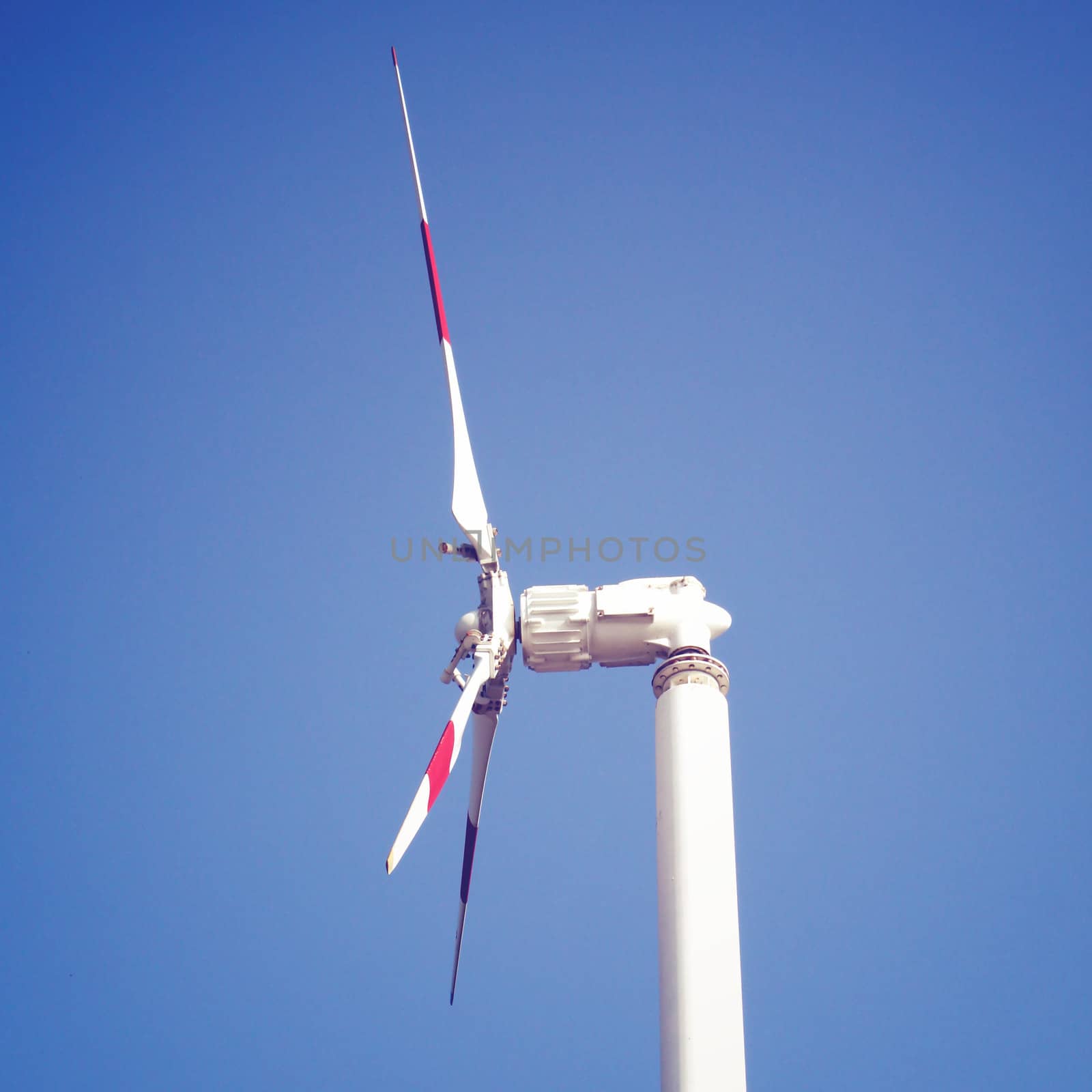 Windmill and blue sky with retro filter effect