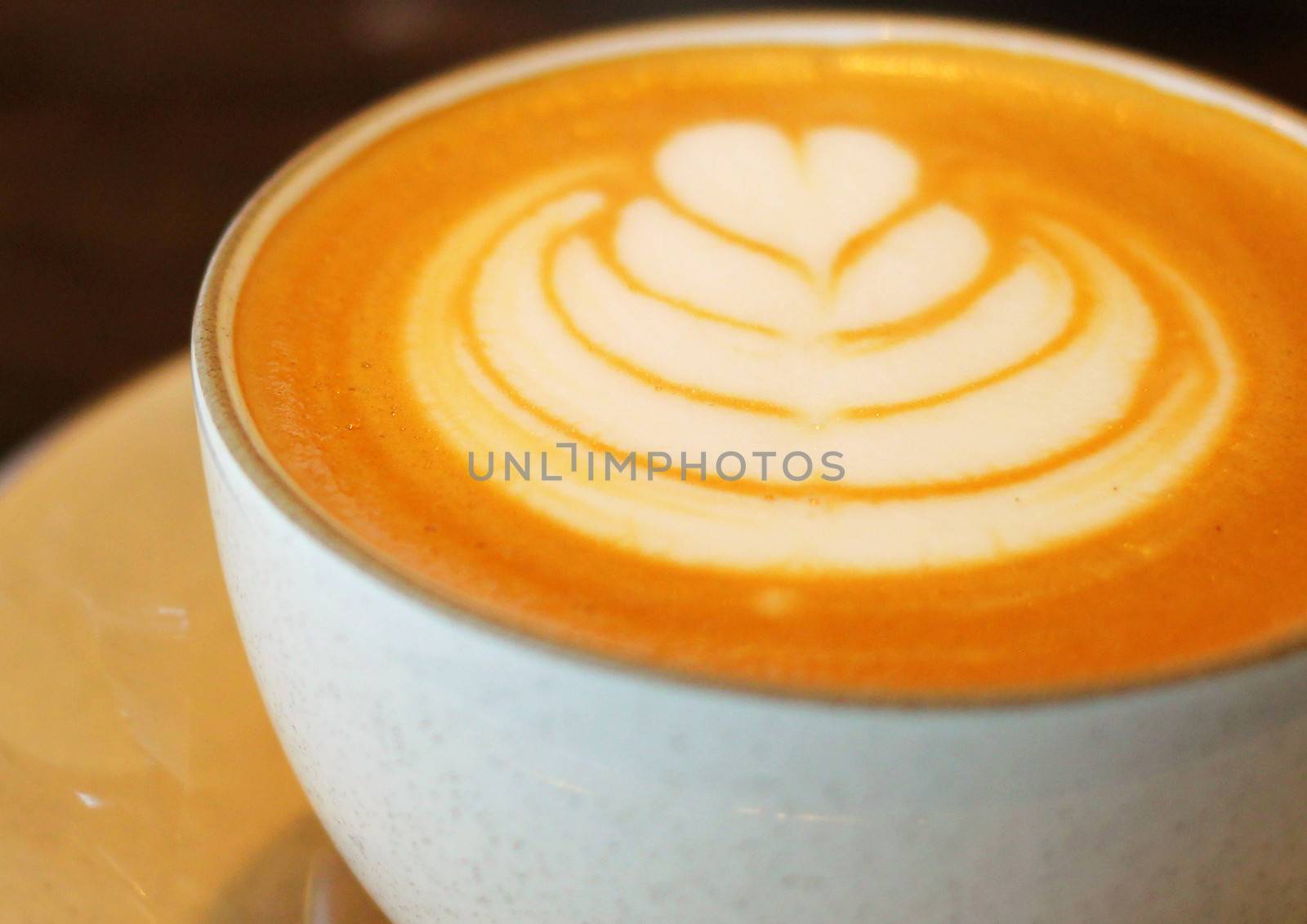 Close up a cup of latte or cappuccino coffee by nuchylee