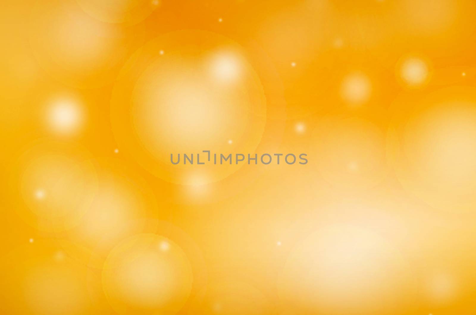 A yellow and gold bokeh background with white flares