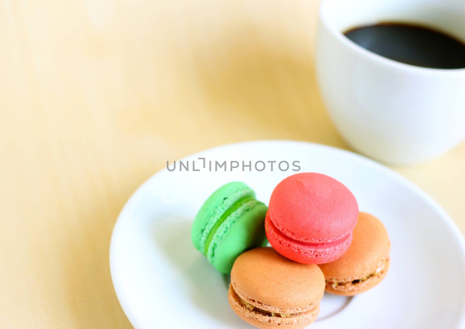 Colorful macaroons and a cup of coffee with copy space by nuchylee