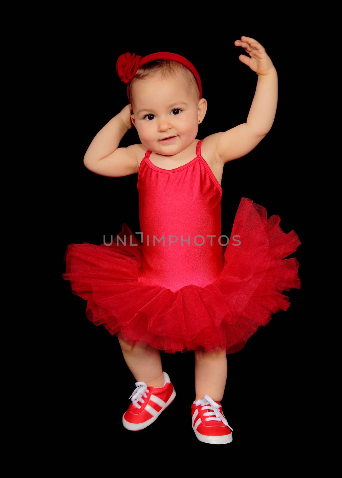 picture of a pretty baby with a dancer dress on a black background