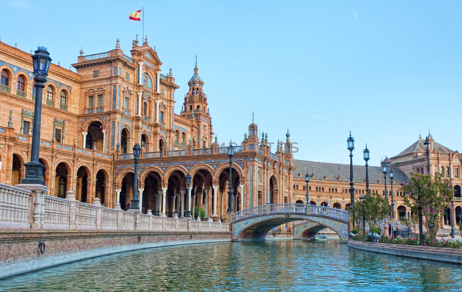 Tourists go boating on the channel on Plaza de Espana in Seville, Spain by elena_shchipkova