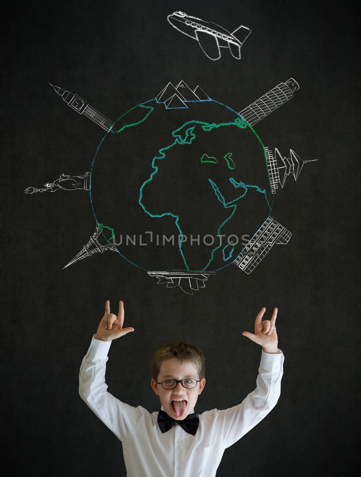 Boy dressed up as business man with chalk globe and world wonders on blackboard background