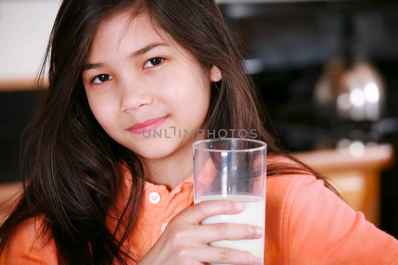 Beautiful young biracial girl drinking milk by jarenwicklund