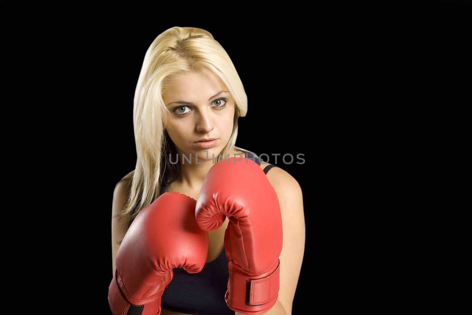 Beautiful young woman training with boxing gloves on blackboard background by alistaircotton