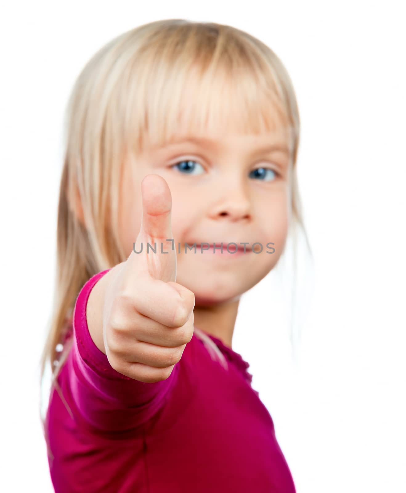 Portrait of cute little girl showing thumb up on white background