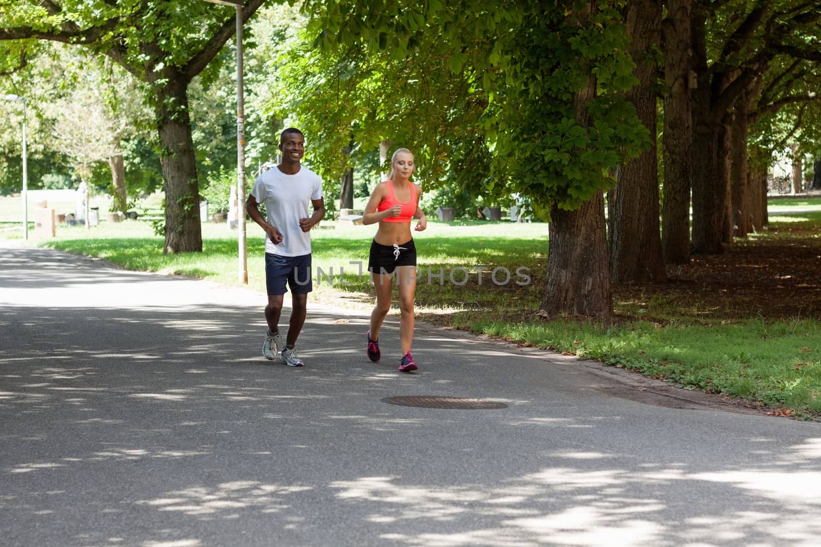 young couple runner jogger in park outdoor summer sport lifestyle 