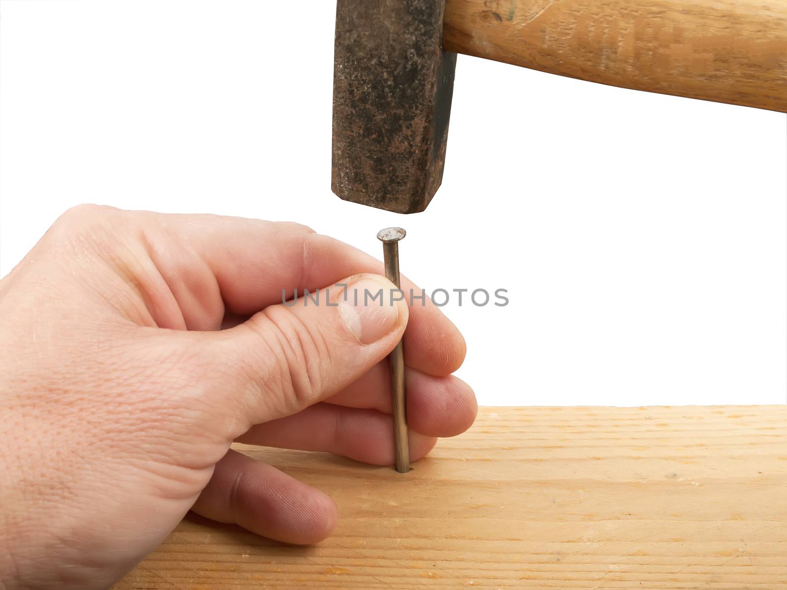 hands with hammer hitting a nail