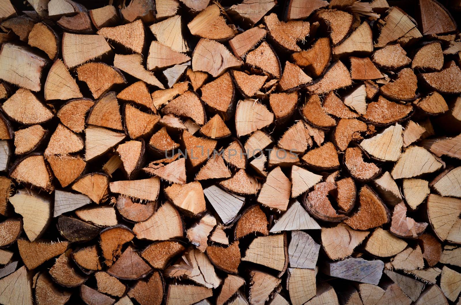 Background Texture Of Stacked Split Wood For Fire