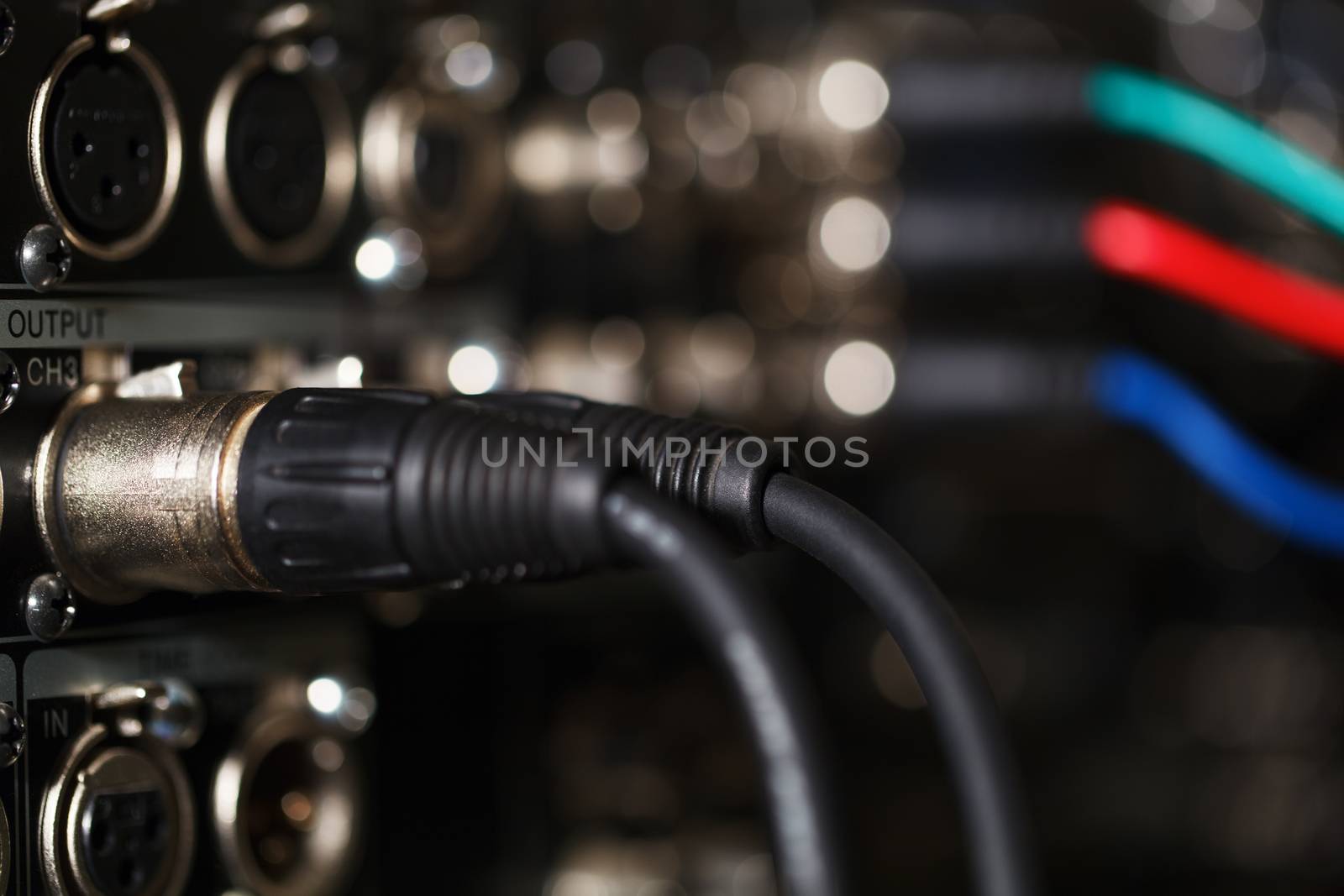 XLR audio digital cables in the rear panel of the professional VCR. RGB video cables in blur.
