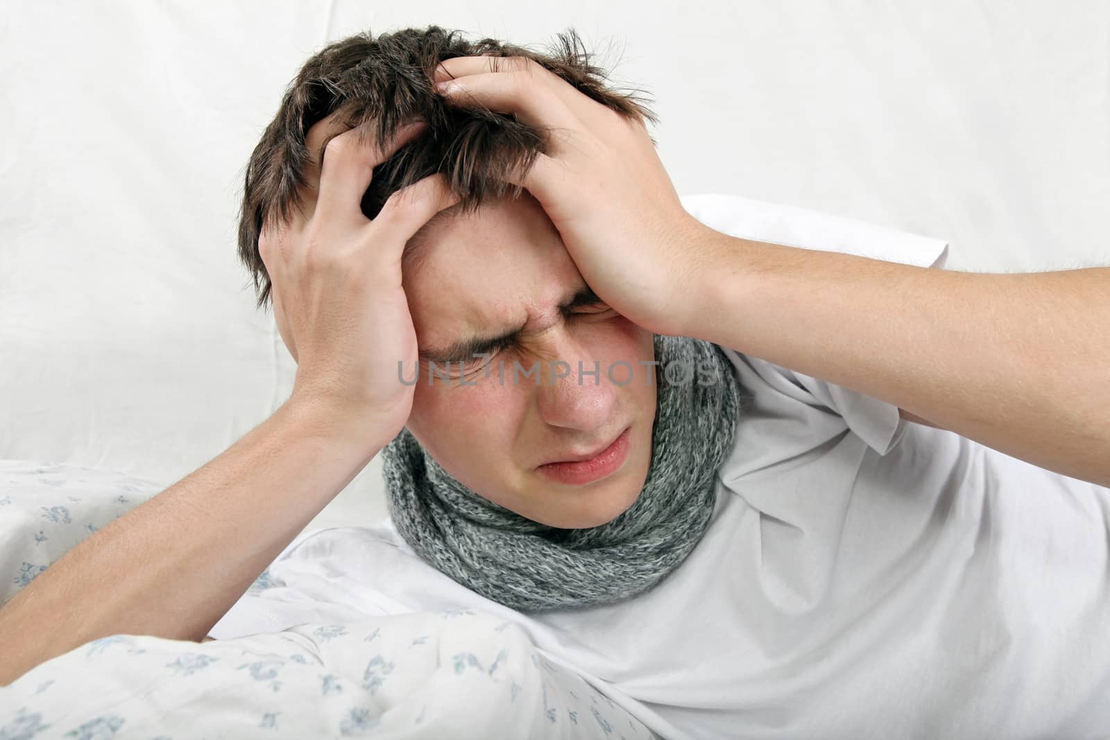 Sick Young Man feels Headache and lying on the Bed