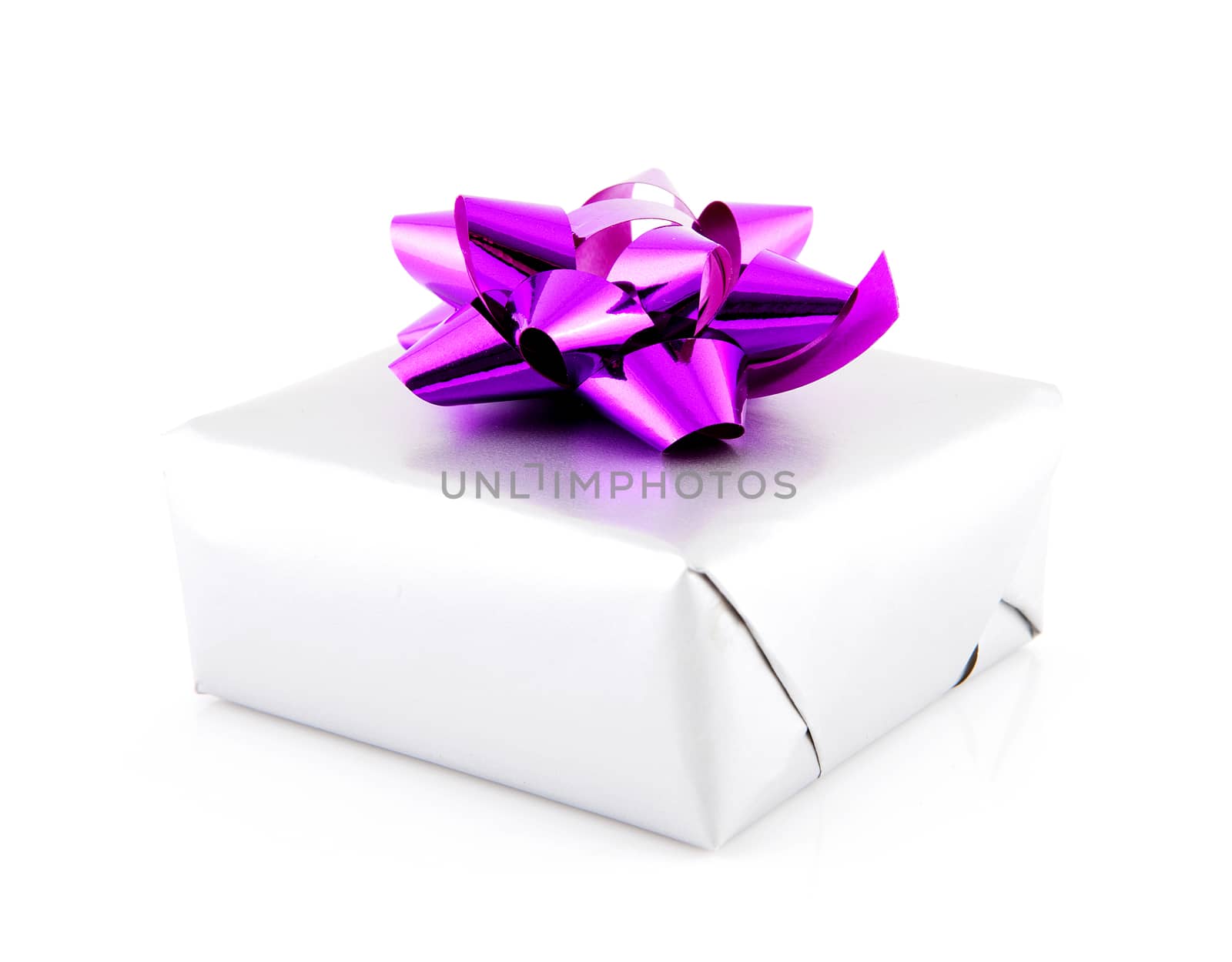 Birthday present with pink bow over white background