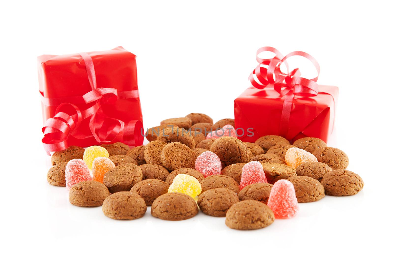 Typical dutch sweets: pepernoten (ginger nuts) and red presents for celebration at 5 december in the Netherlands over white background