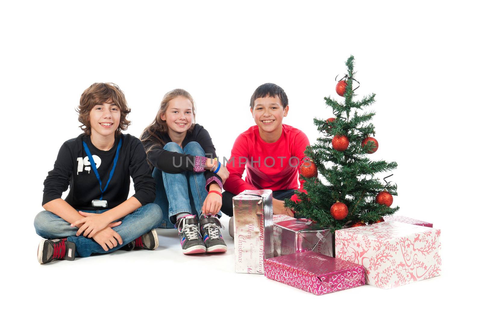 Two boys and a girl, celebrating Christmas on a white background