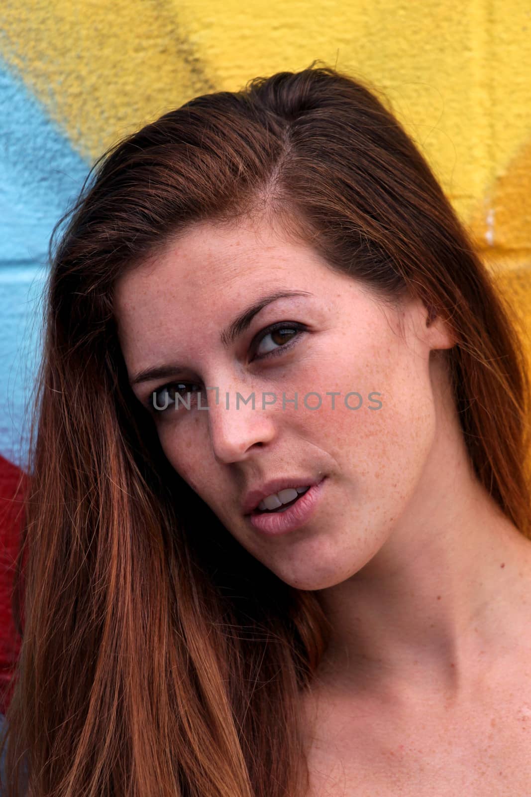 Young WomanYoung woman standing in front of a colorful background.