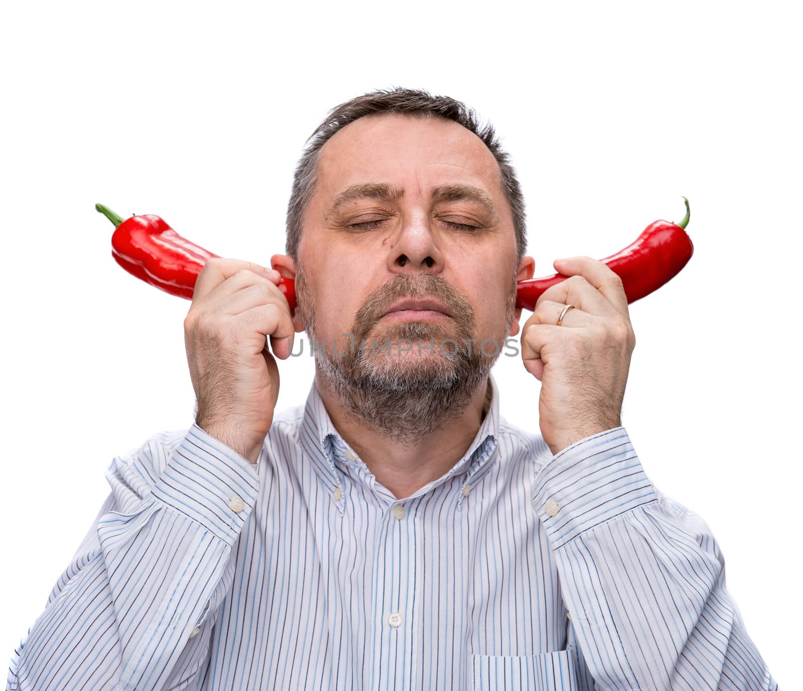 Conceptual portrait of a middle-aged man with a red peppers closed the ears. Isolated on white