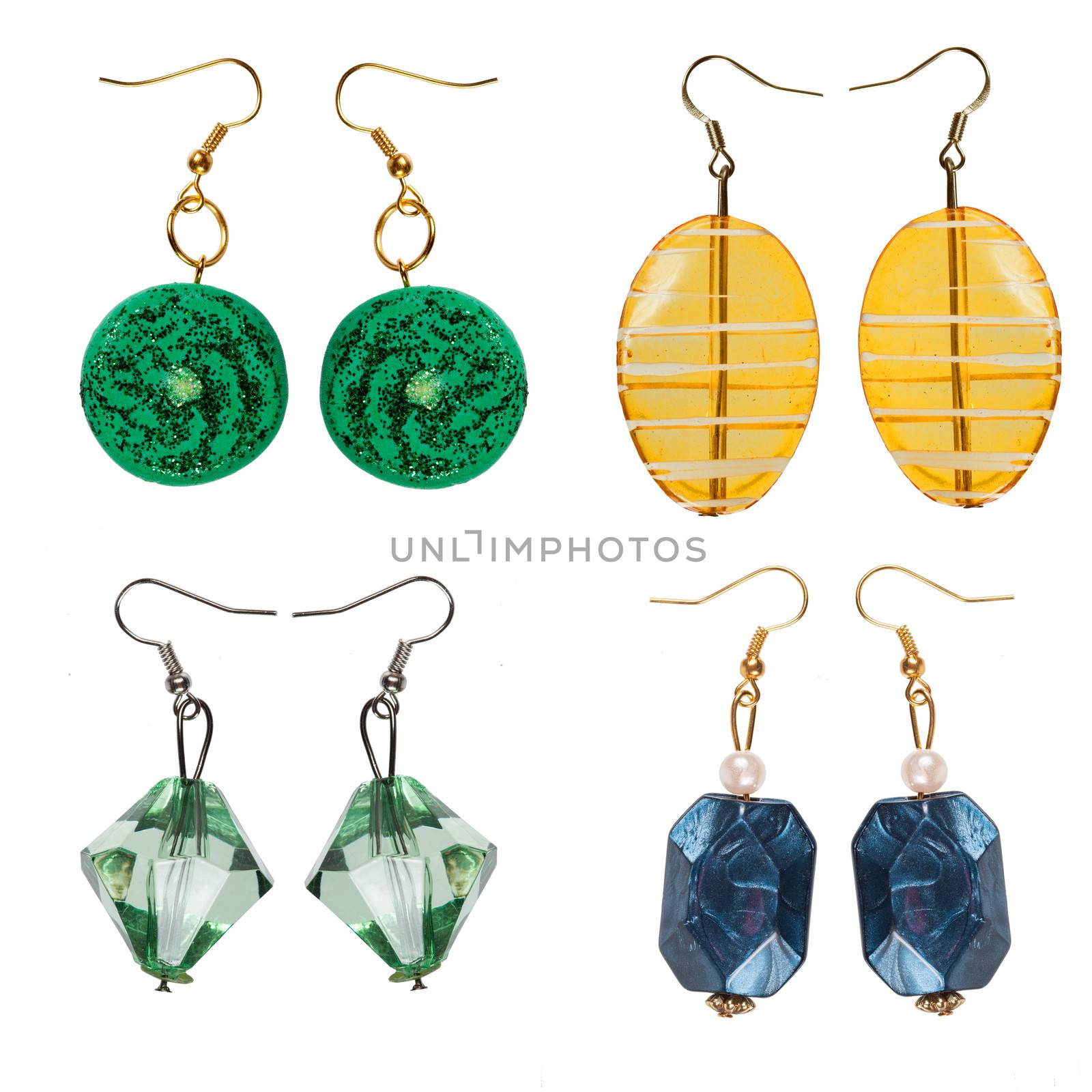 Earrings  made of plastic and glass   isolated on white background. Collage.