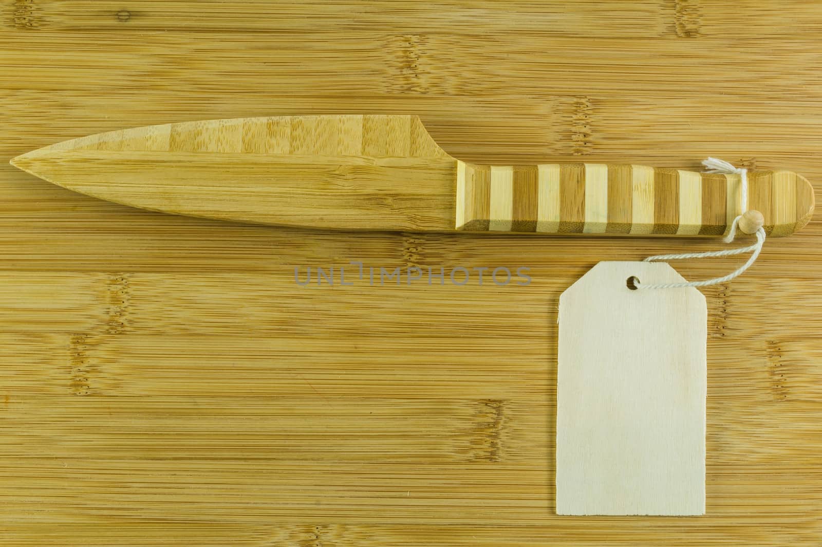 Wooden knife with text box on wooden background