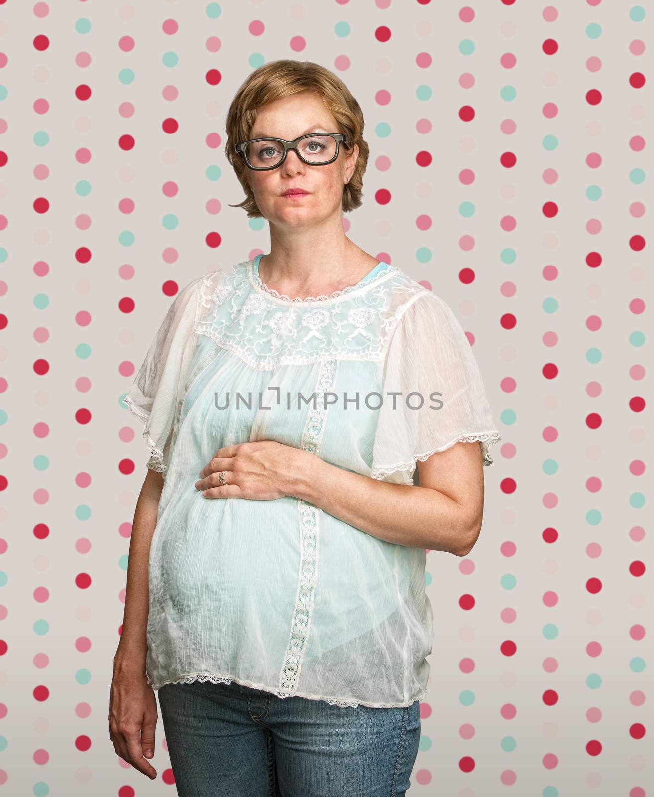 Calm pregnant woman on polka dot background