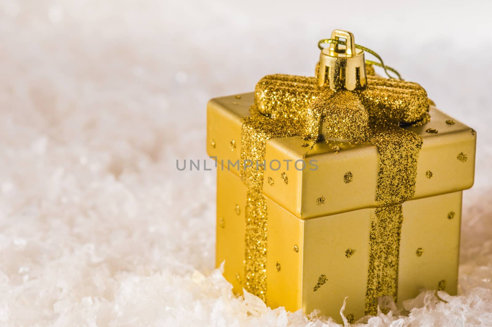 Golden Christmas decoration on artificial snow