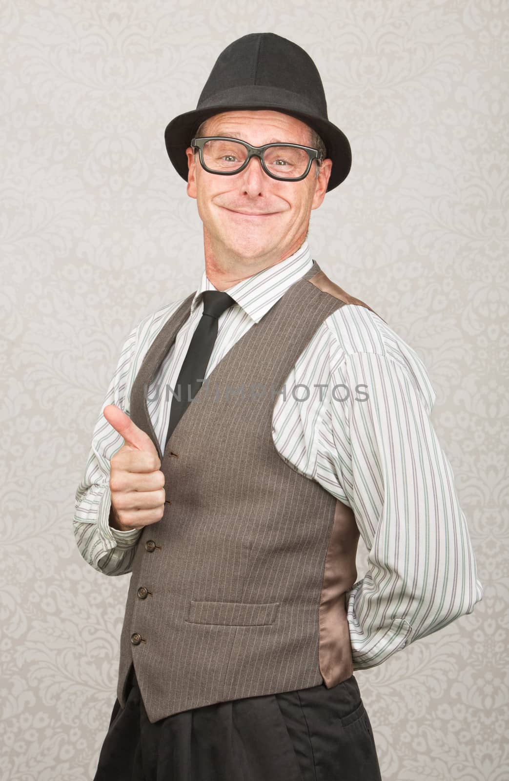 Cute smiling man giving thumbs up gesture