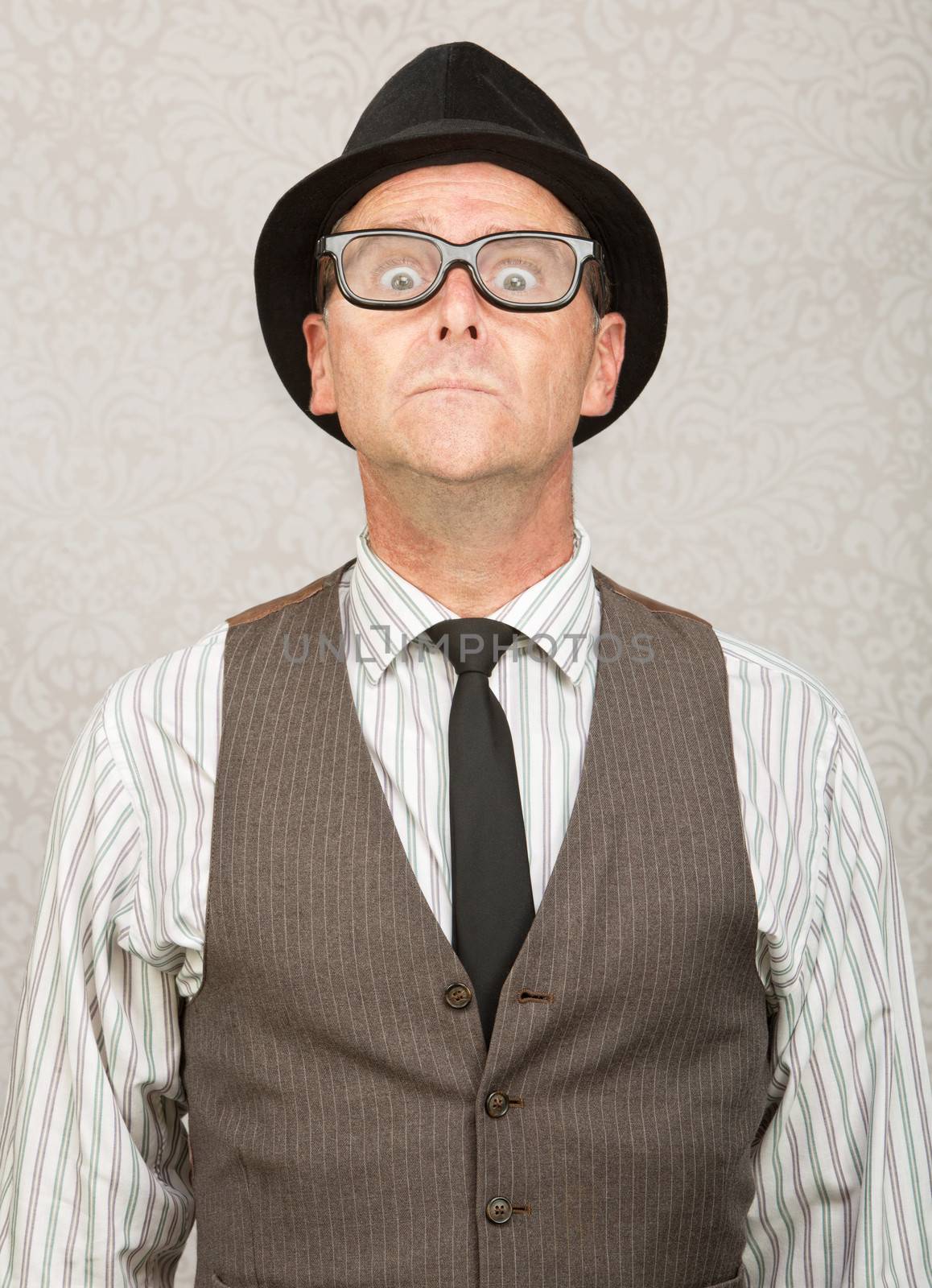 Frightened white businessman with hat and eyeglasses