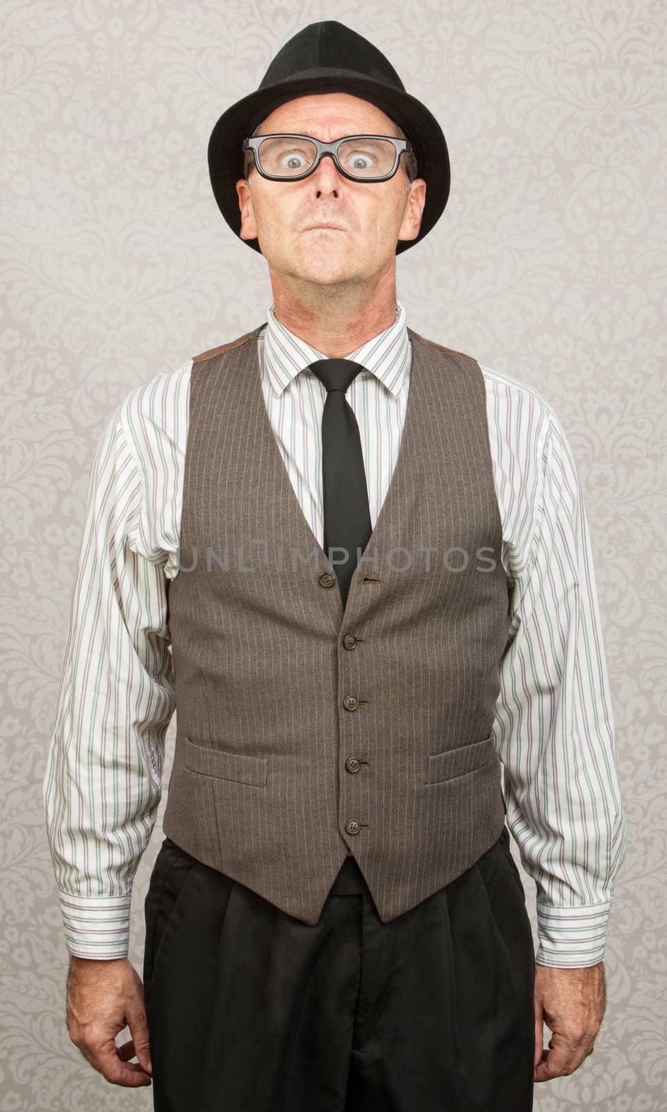 Scared stiff businessman with hat and eyeglasses