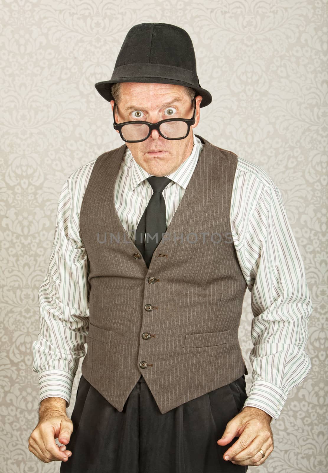 Dumfounded businessman with hat and eyeglasses
