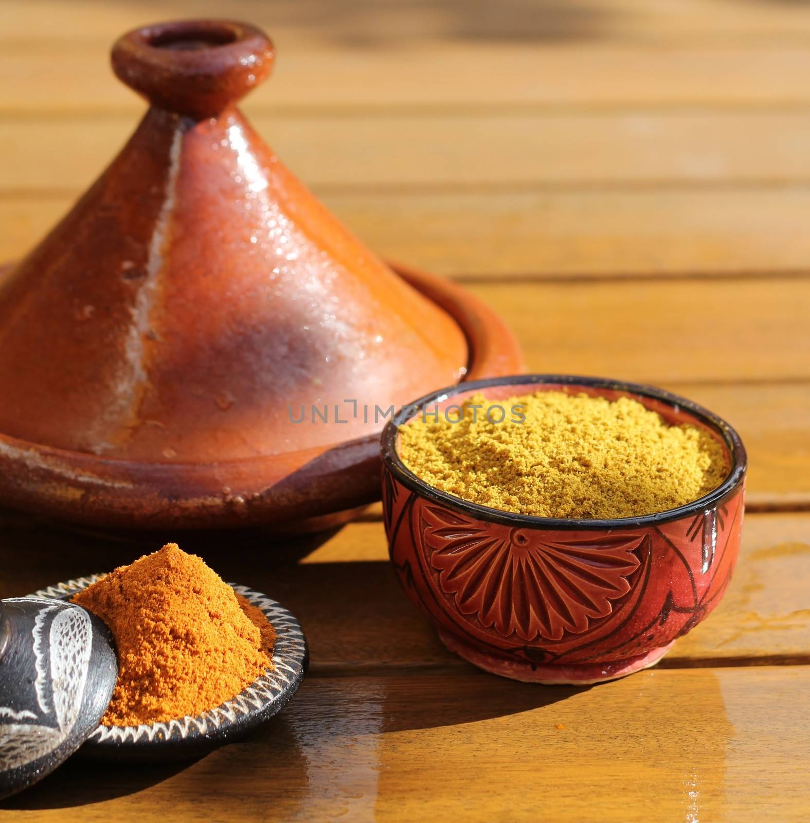 a tagine with some spices in a bowl.