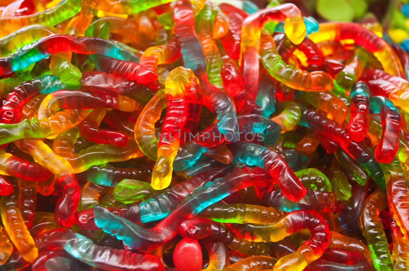 Many colorful candies on market stand .