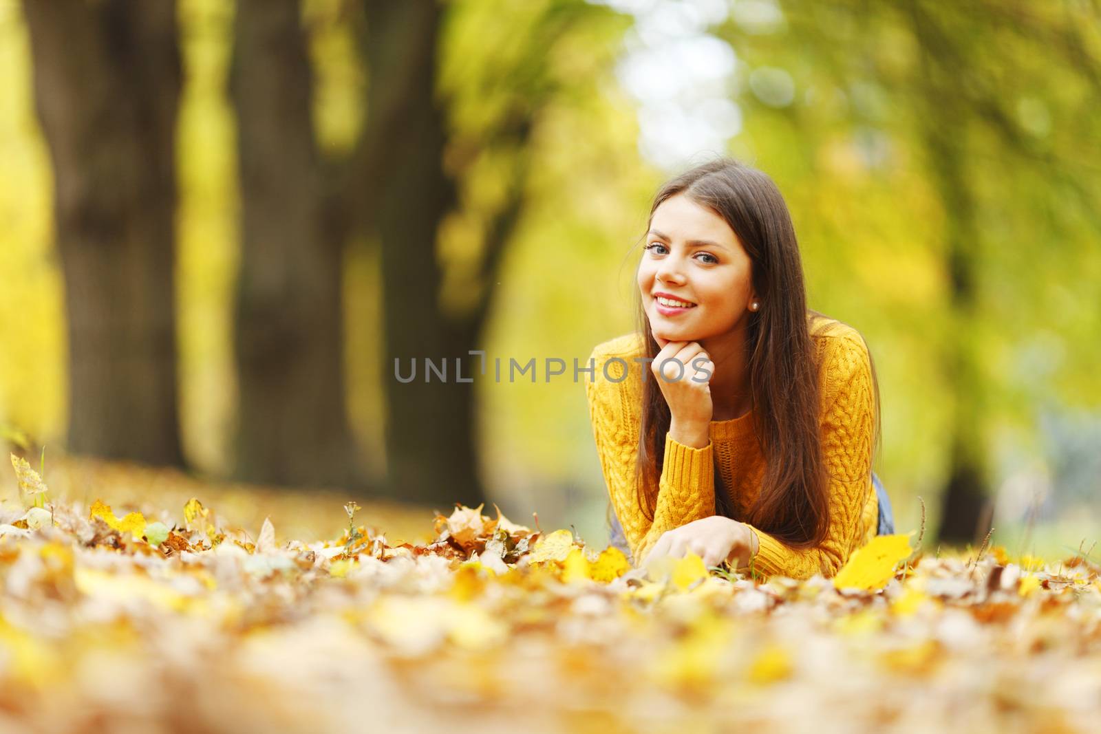 Girl laying on autumn leafs by Yellowj
