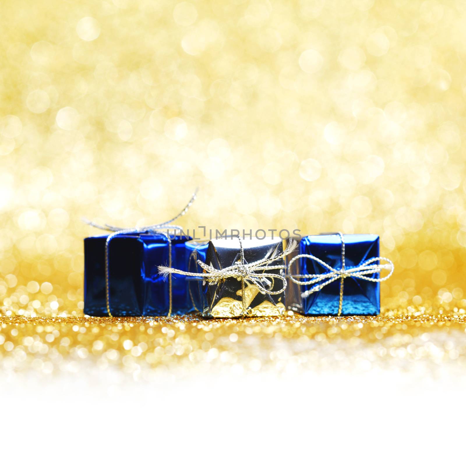 Christmas gifts close-up on golden background
