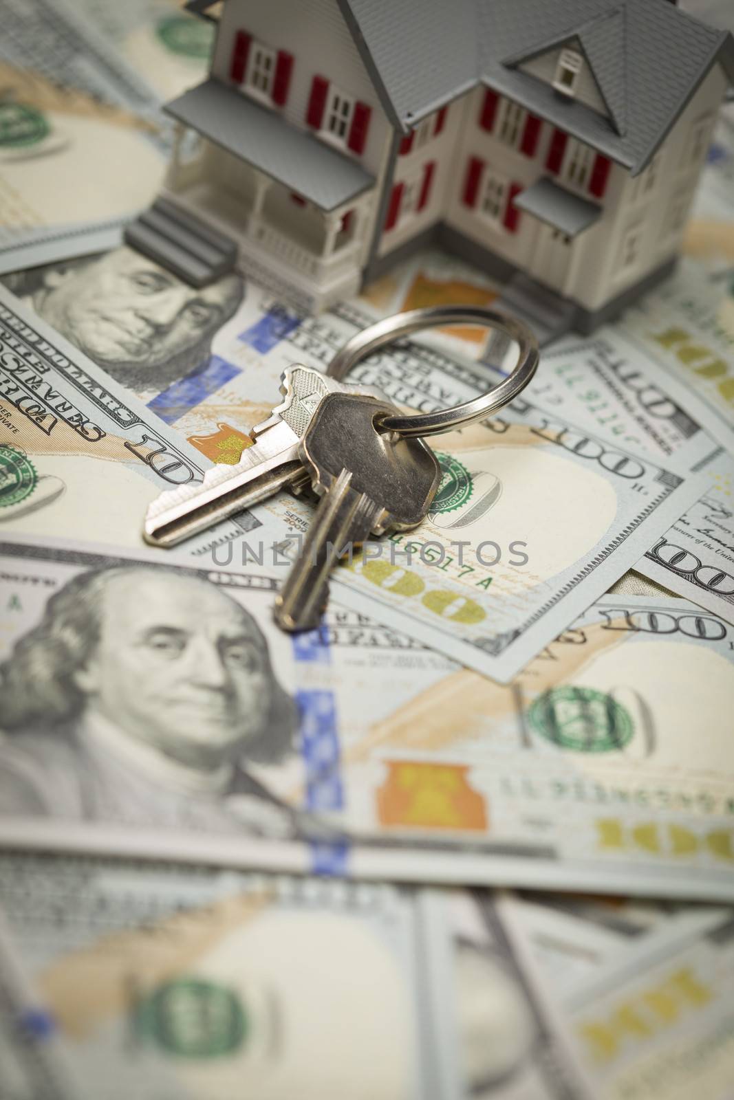 Small Model House and Keys on Newly Designed U.S. One Hundred Dollar Bills.