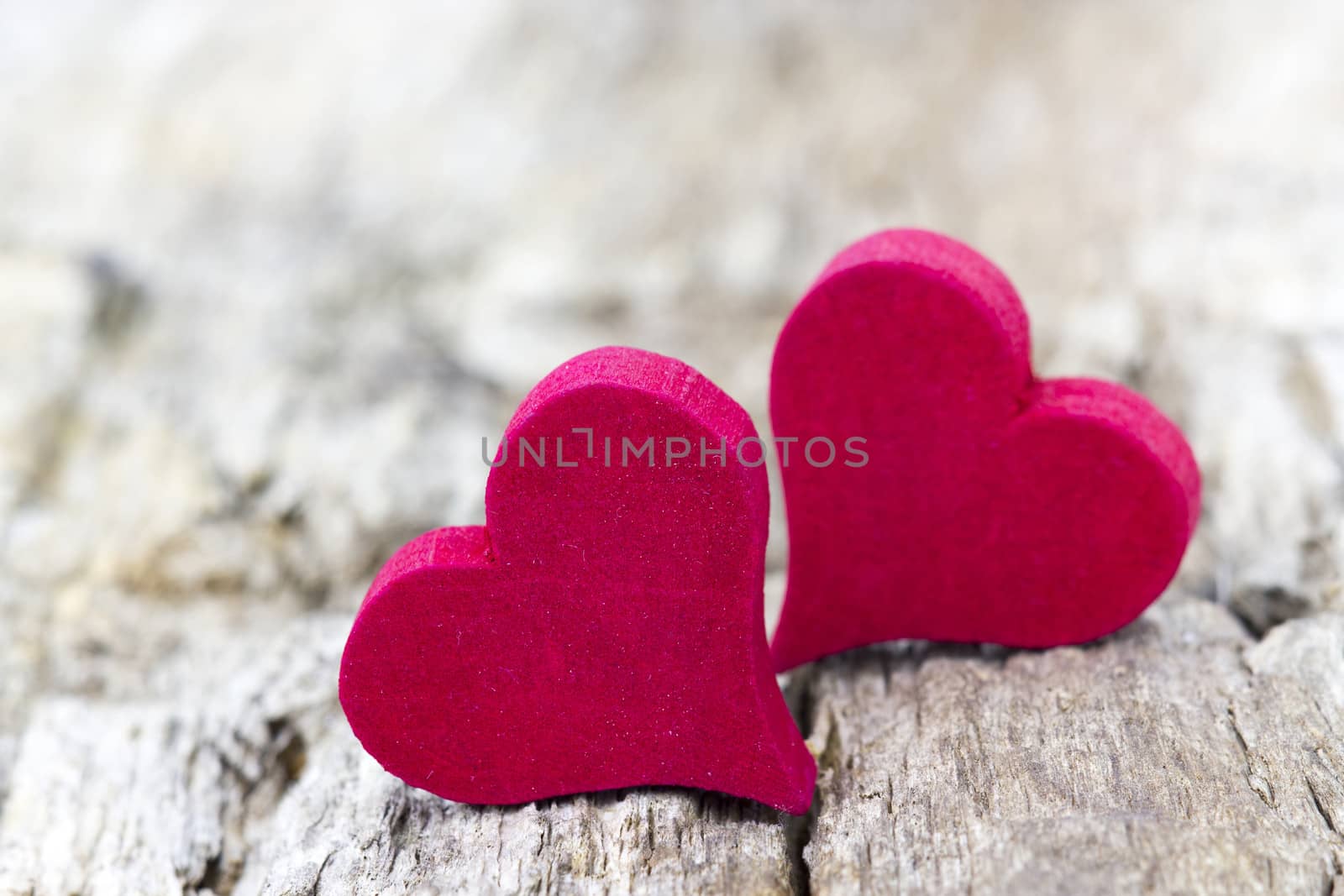 two red hearts on wooden background