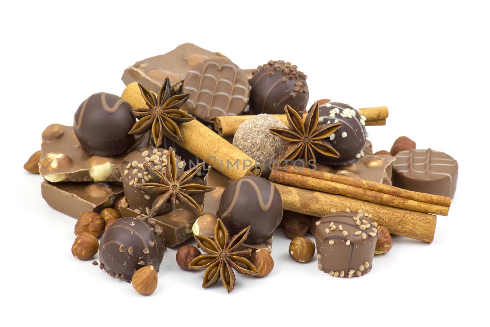 chocolate, spices and nuts on white background