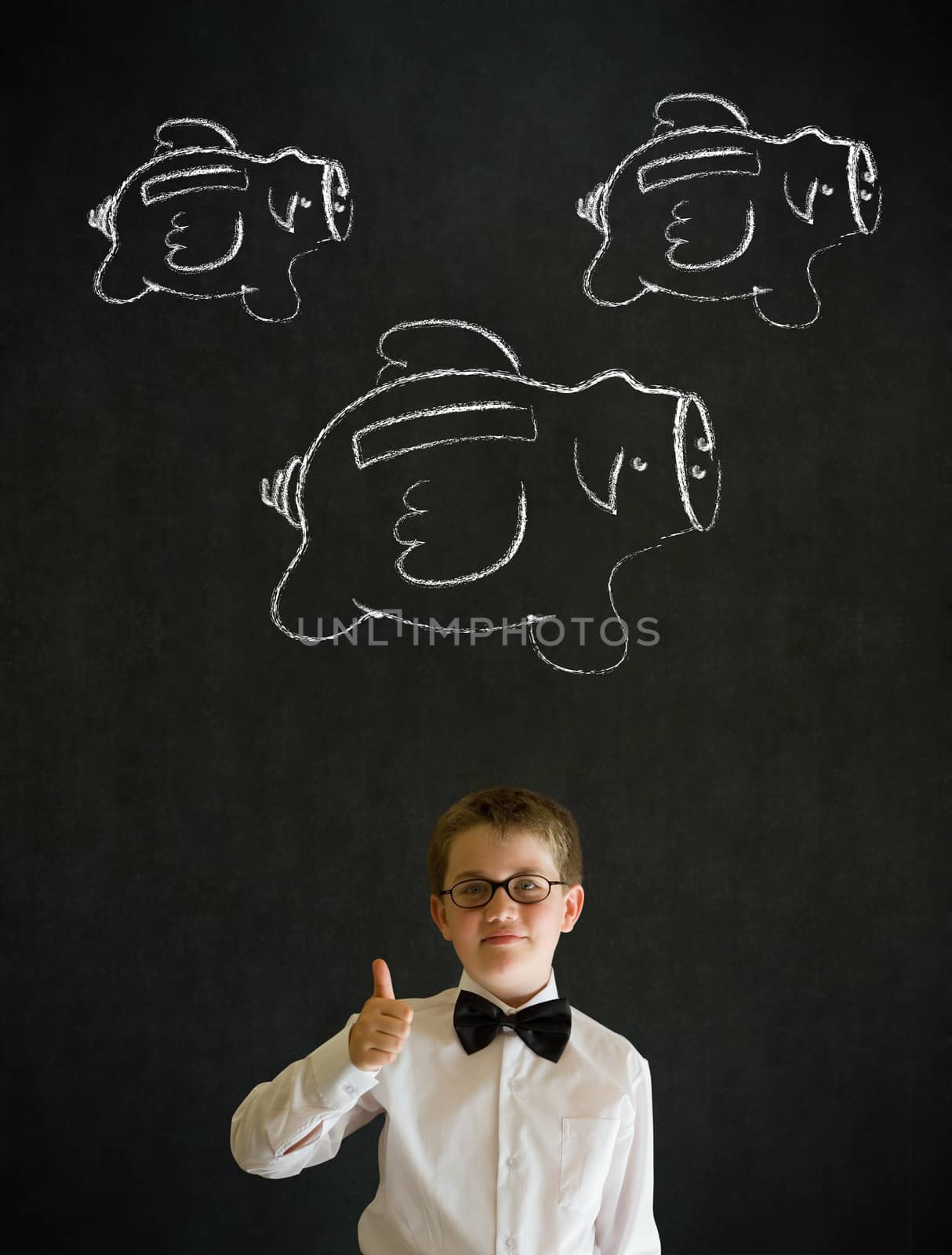Thumbs up young business boy with flying money piggy banks in chalk on blackboard background by alistaircotton