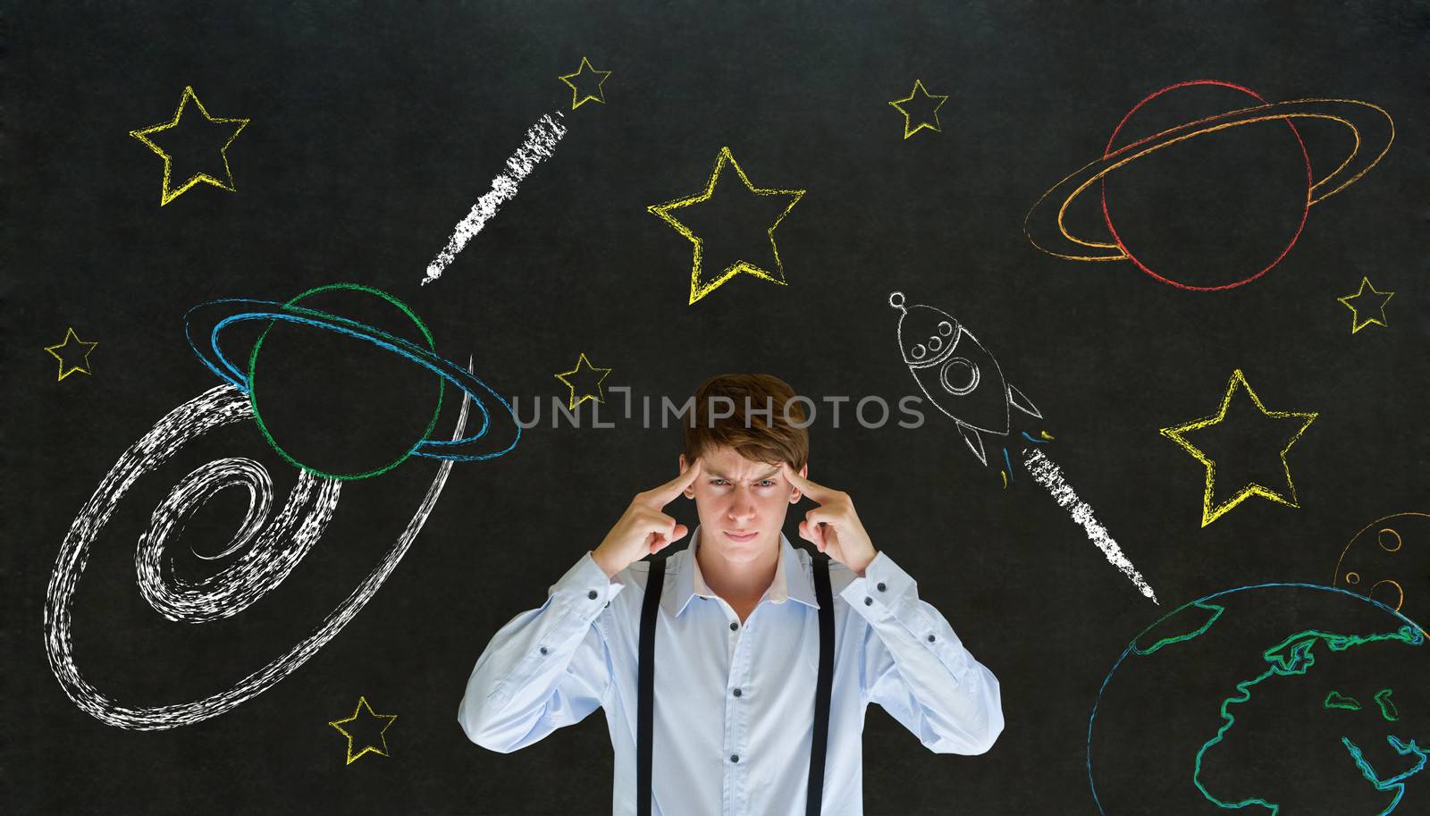 Businessman thinking with chalk universe planet solar system on blackboard imagining space travel by alistaircotton