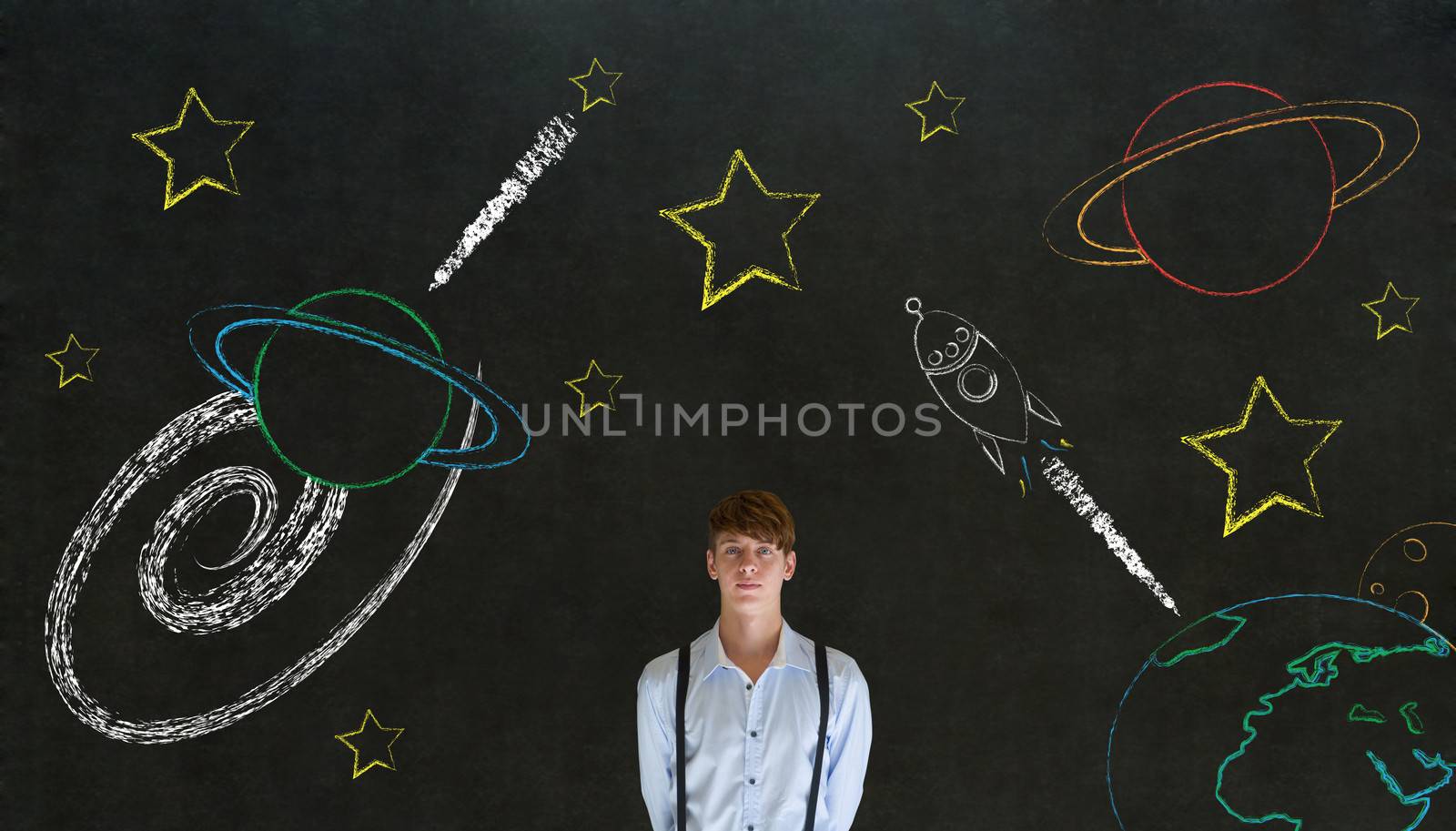 Businessman with chalk universe planet solar system on blackboard imagining space travel by alistaircotton