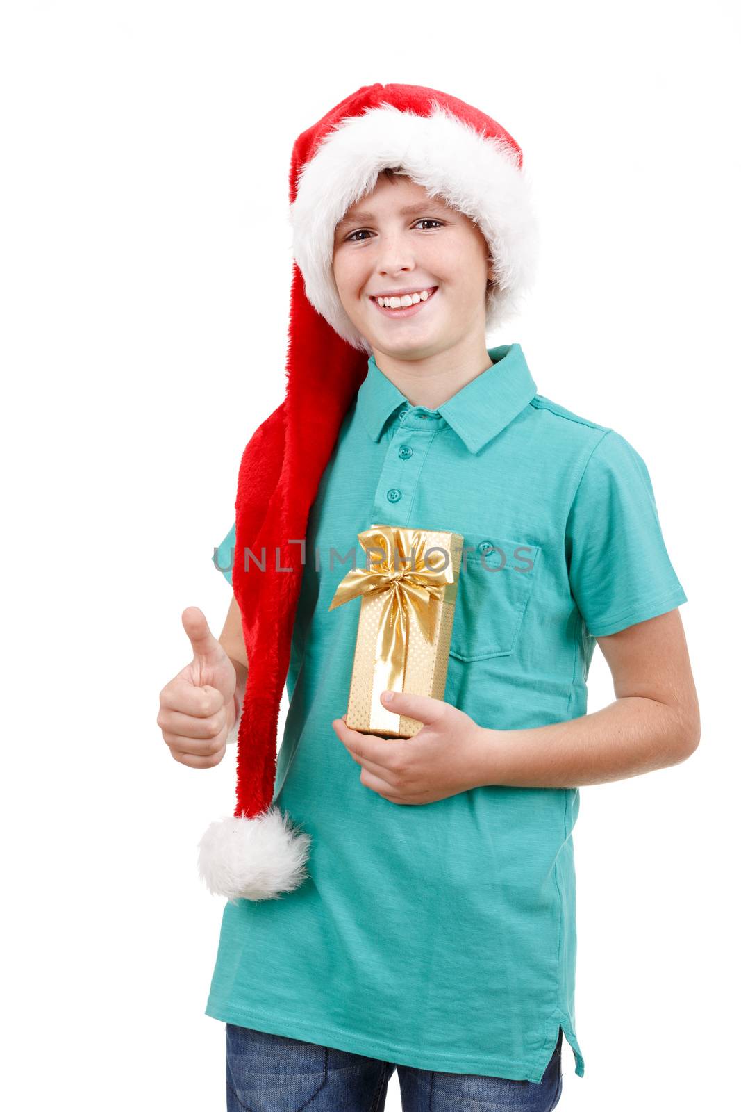 happy teenage boy with santa claus hat isolated on white and showing his christmas gift