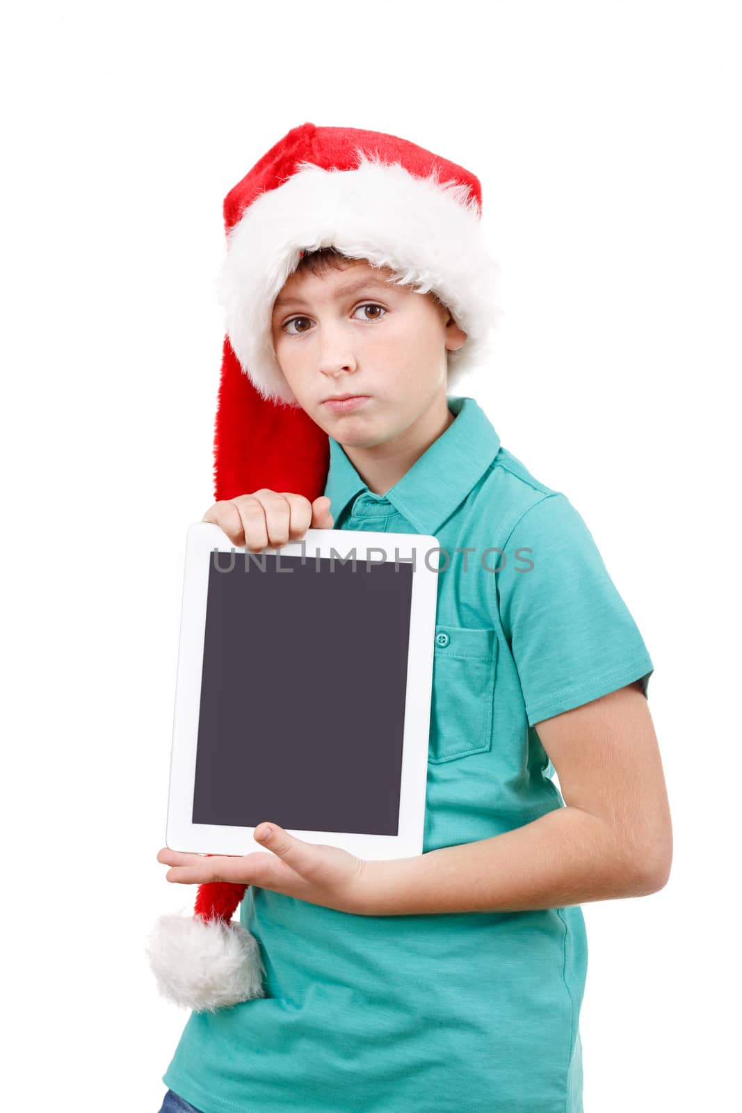 teenage boy with santa claus hat isolated on white and showing his new digital tablet 
