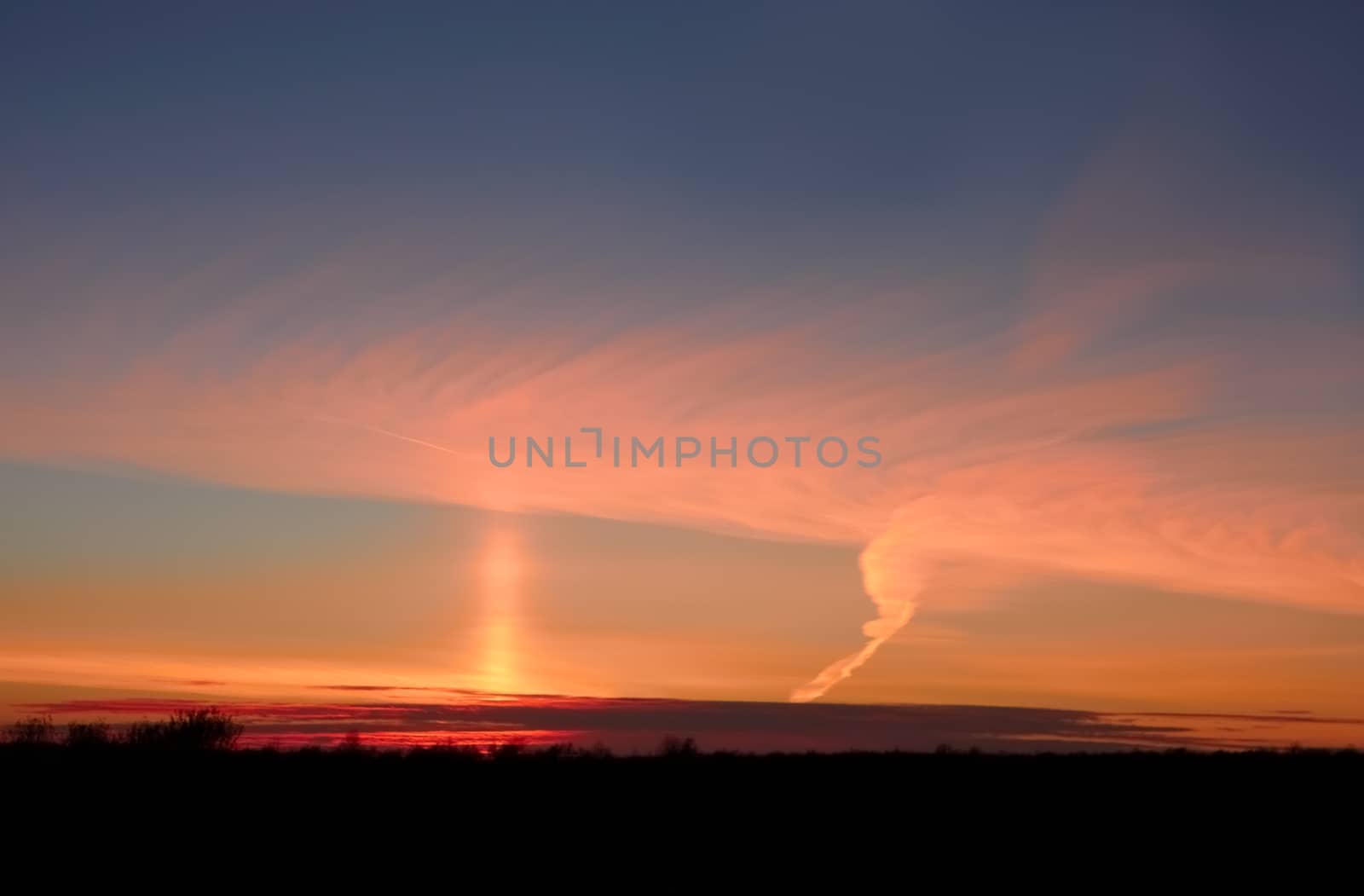 Vertical pillar of sunlight in the sky after sunset, the phenomenon took place in lovely autumn mainly clear weather in October