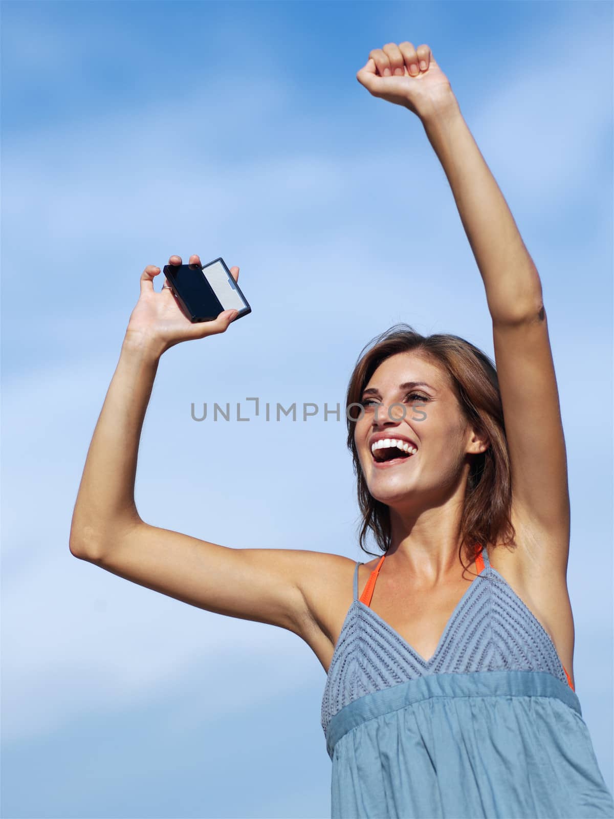 happy woman with mobile phone on sky backgroound 
