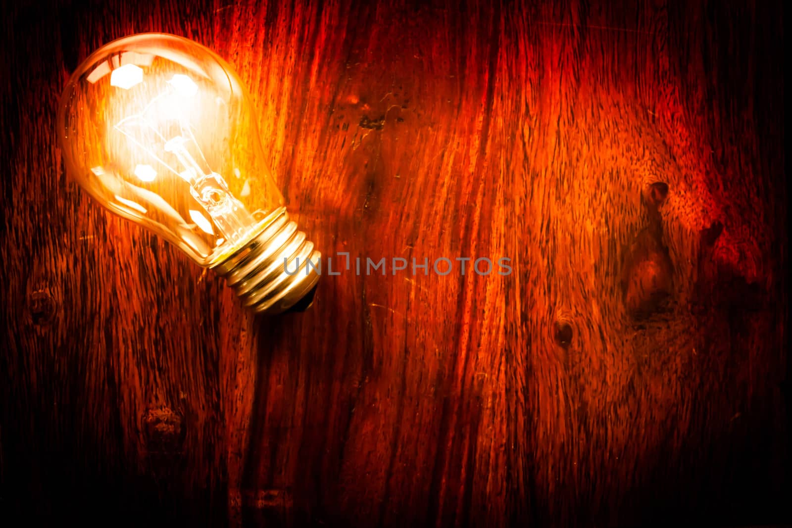 Bright light bulb on a wodden table