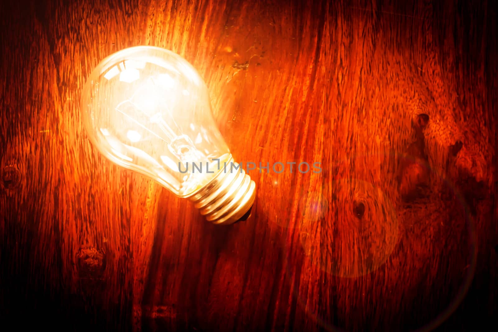 Bright light bulb on a wodden table