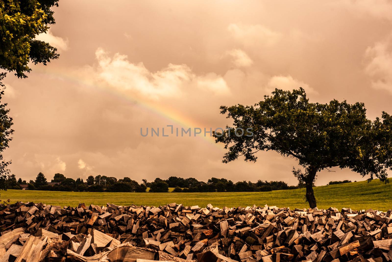 Countryside scenery with a rainbow and cloudy weather