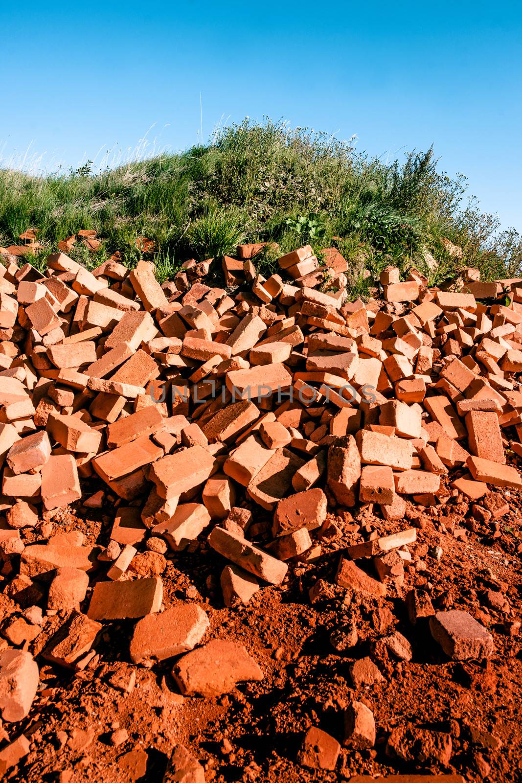 Pile of red bricks in the nature