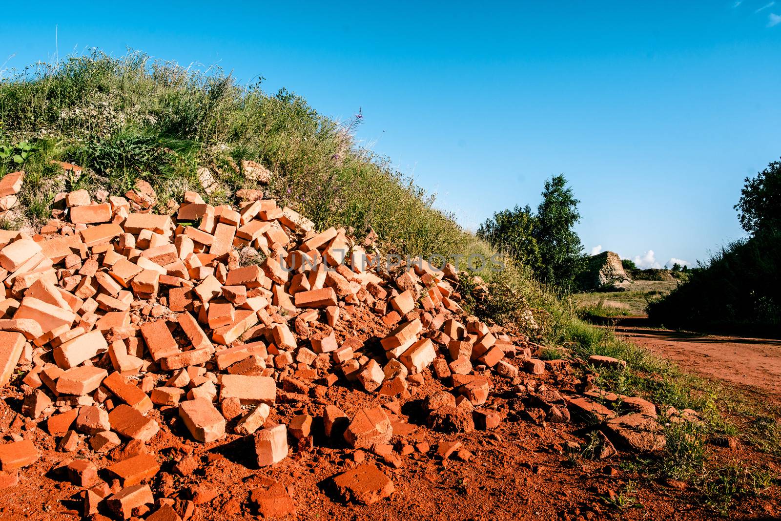 Pile of red bricks in the nature
