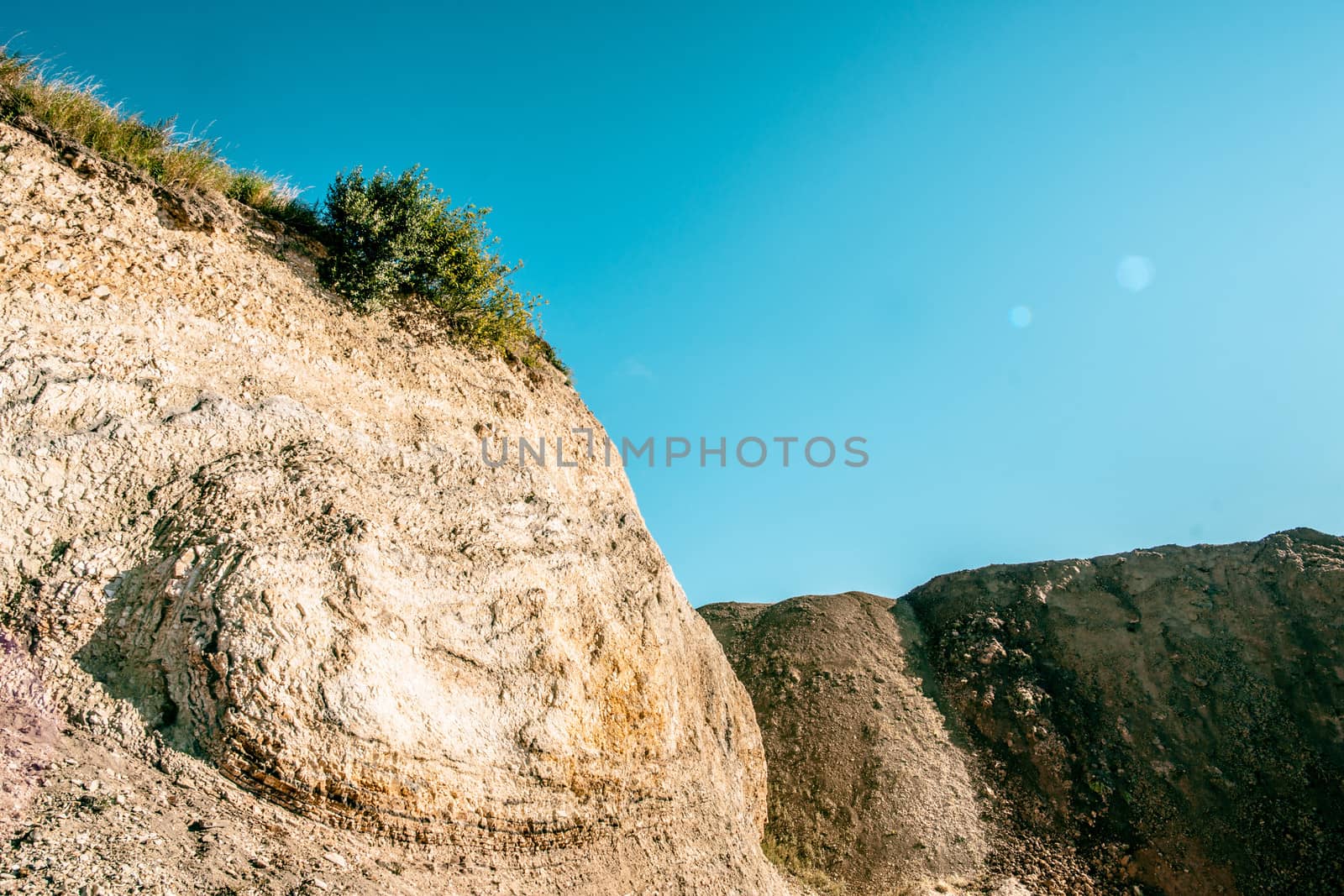 Dry canyon surrounded cliffs and blue sky