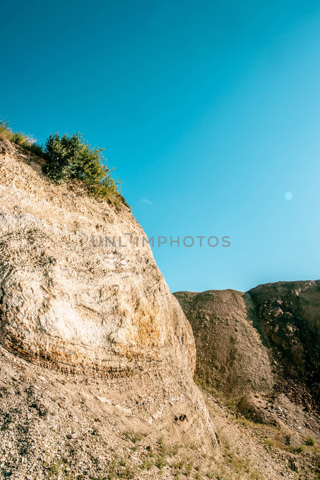 Dry canyon surrounded cliffs and blue sky