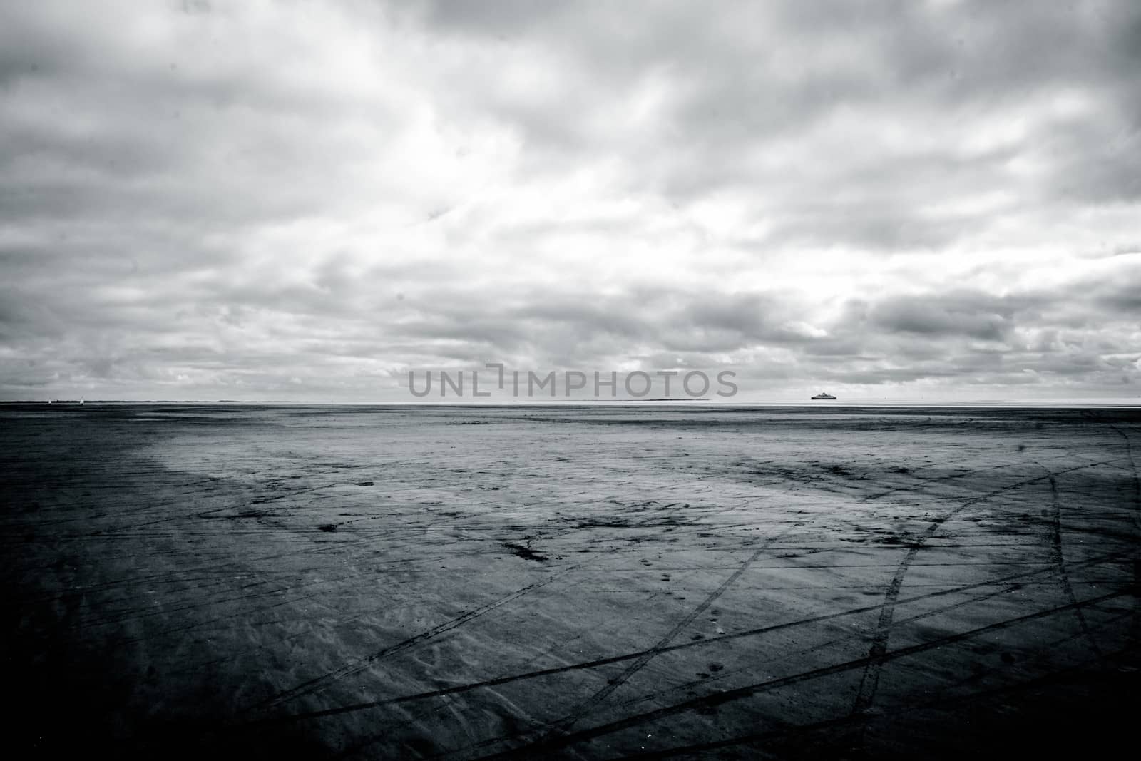 Black and white photograph of low tide beach